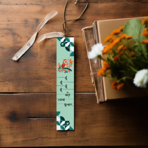 Whimsical Marathi Owl Bookmark on a wooden table next to flowers.